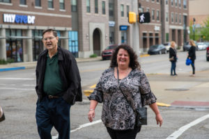 Tammie Katin (right) and her husband Joe (left) walk down Wabash Ave. to meet Tammie's Scott College of Business faculty for lunch on May 5. Buildings along Wabash are visible in the background. 